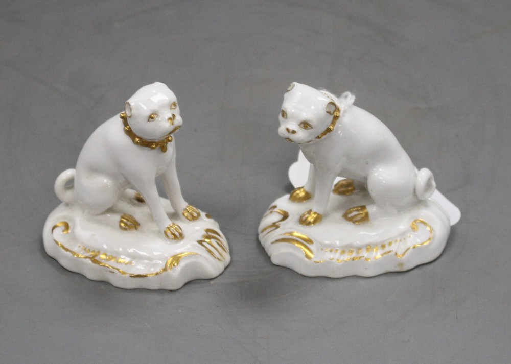 A pair of Derby gilt and white seated figures of pug dogs, c.1830, H. 5.7cm